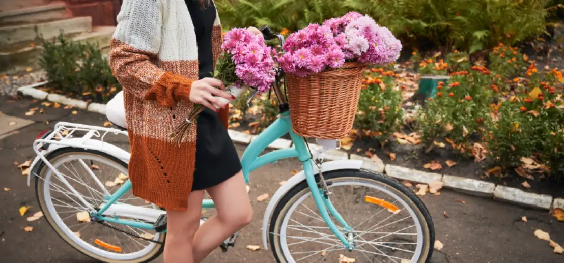 Dame op fiets neemt bloemetje mee